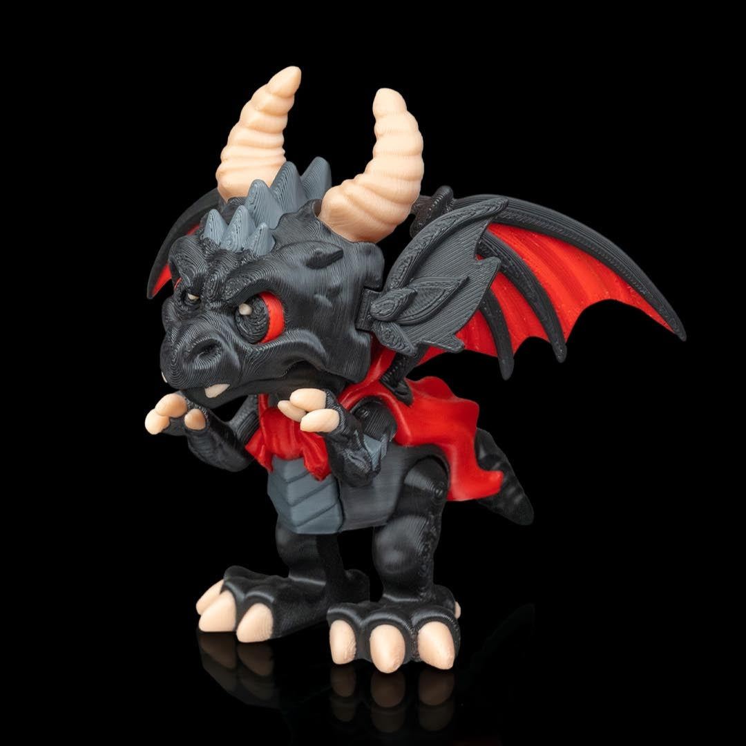 Black dragon figurine with red cape and horns on a black background